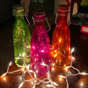 3 purple, green and orange glass bottles not sure of brand